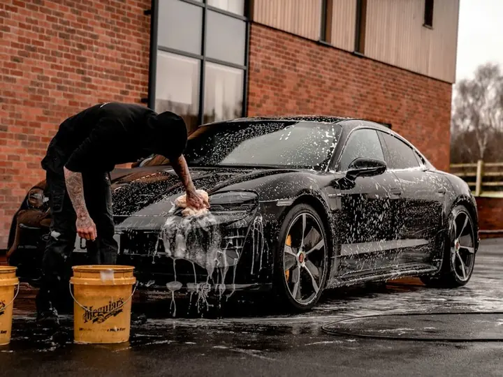 A man washing a car by hand