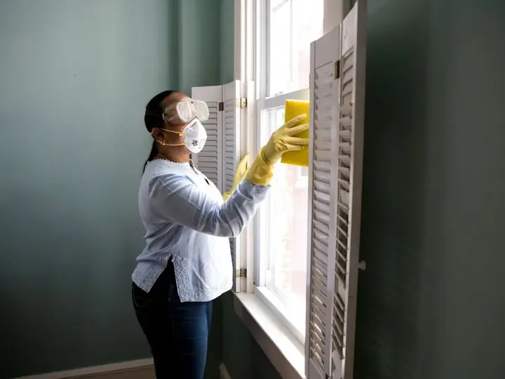 A woman cleaning a window