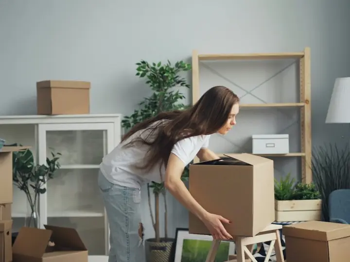 A woman packing boxes to move house